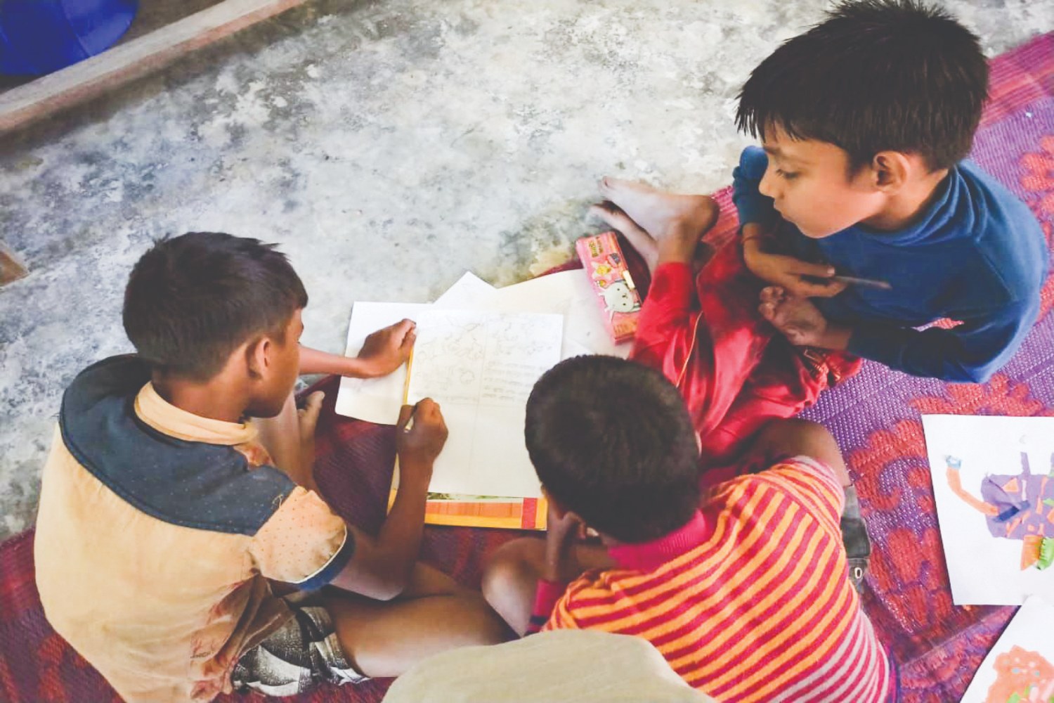 Children sharing ideas while making art