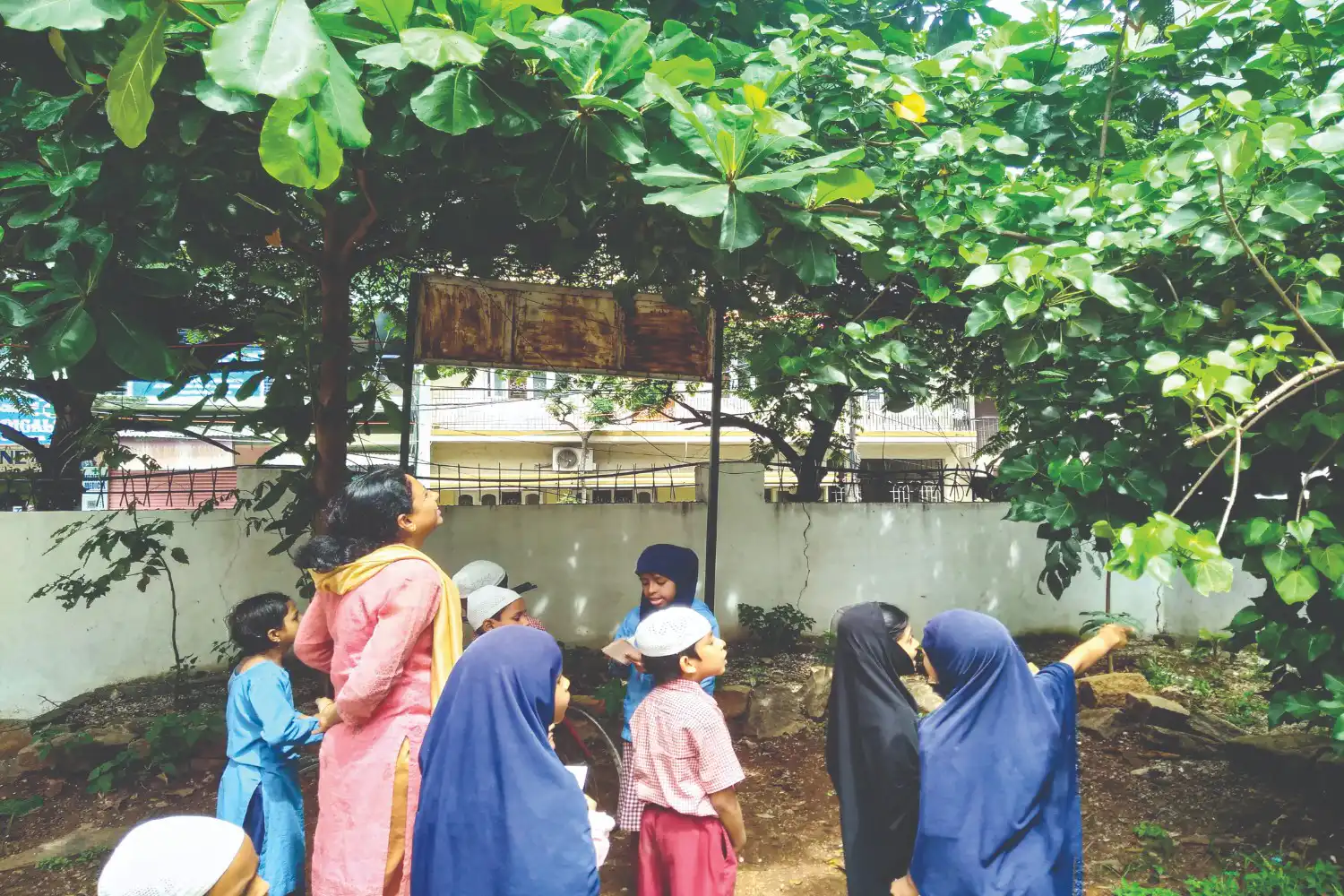 A teacher conducting an outdoor session on plants