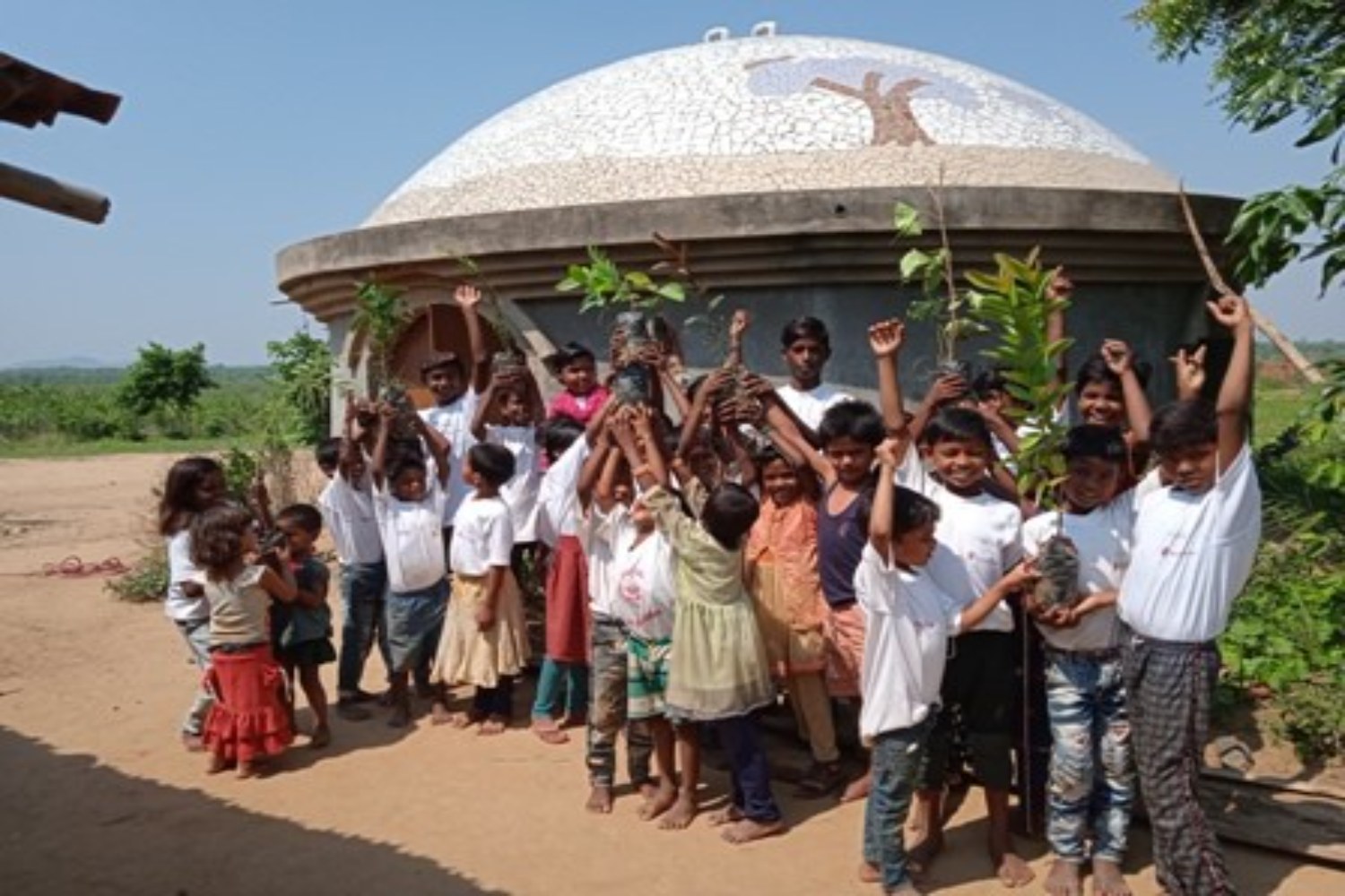 Children with saplings of diverse indigenous species of trees