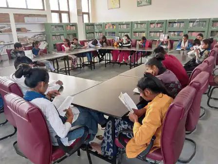 
students engaged in a group study session at a library